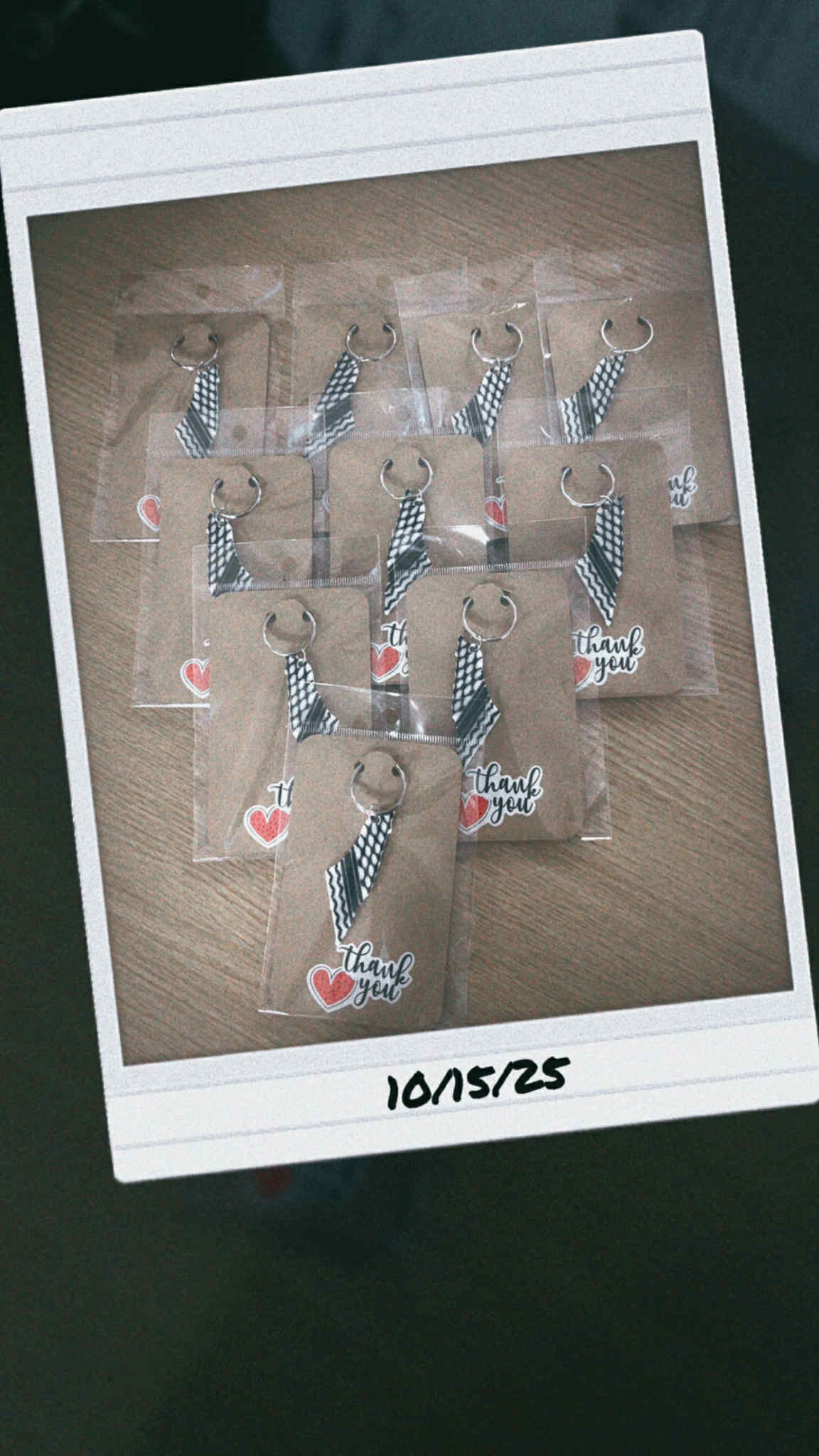 “Kuffiyeh pattern keychains packaged with thank you tags on wooden surface.”

“Set of Palestinian-inspired black and white woven fabric keyrings.”

“Cultural kuffiyeh keychain with metal loop symbolizing solidarity and heritage.”